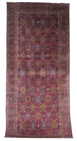 A large Kirman carpet, South East Persia, circa 1900, 23 ft x 10 ft 6 in (701 x 323 cm) some minor wear