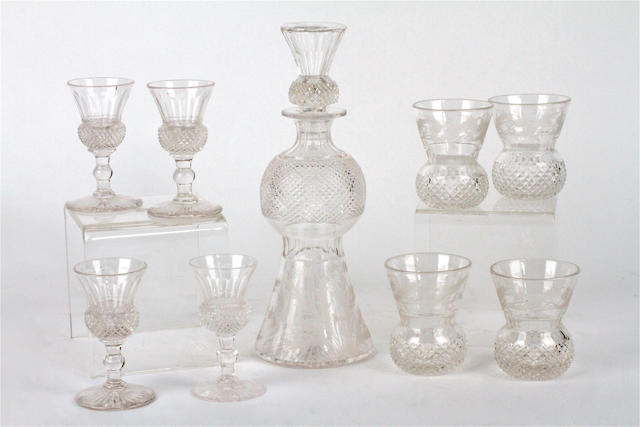 An engraved and cut glass thistle form decanter and stopper and two sets of four similar glasses Victorian and later