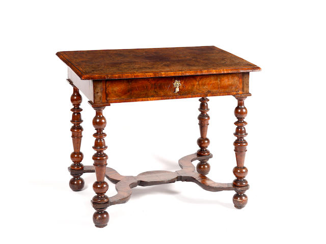 A William & Mary side table,the oblong top, frieze and H-stretcher oyster veneered in olive wood, box line inlay to the top forming scrolls and heart motifs on turned legs, 81cm wide x 57cm deep x 69cm high, (31.5" wide x 22" deep x 27" high)