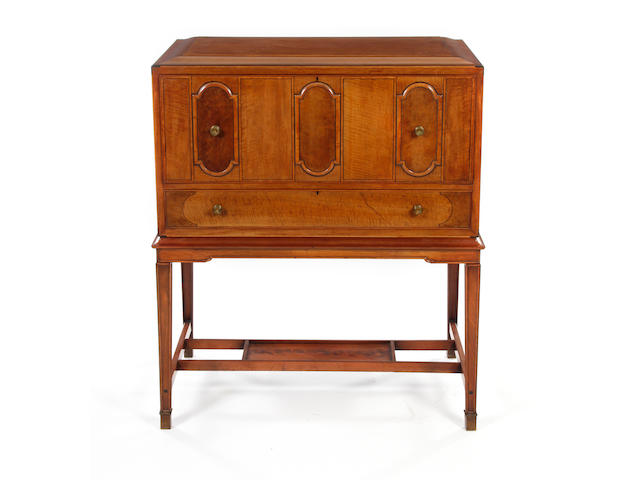 A fine Arts & Crafts mahogany, satinwood and ebony-inlaid secretaire cabinet on stand By James Henry Sellers (1861 - 1954)