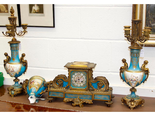 A 19th century French Rococo style gilt metal and Sevres style porcelain matched three piece clock garniture