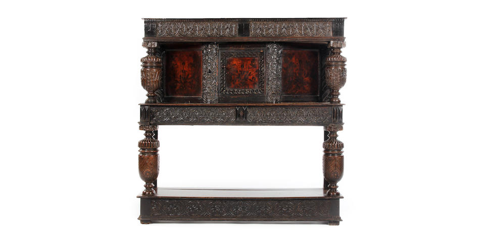 A rare early 17th century oak and sycamore standing livery cupboard With ebonized detail and highly unusual penwork marquetry-style decoration