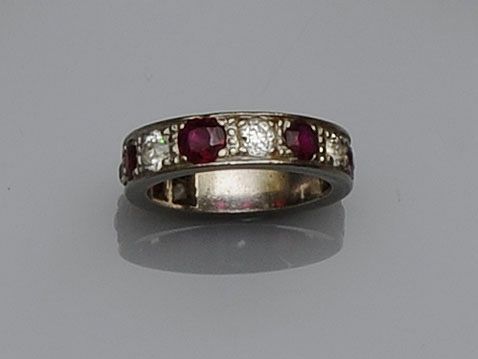 A ruby and diamond half hoop eternity ring