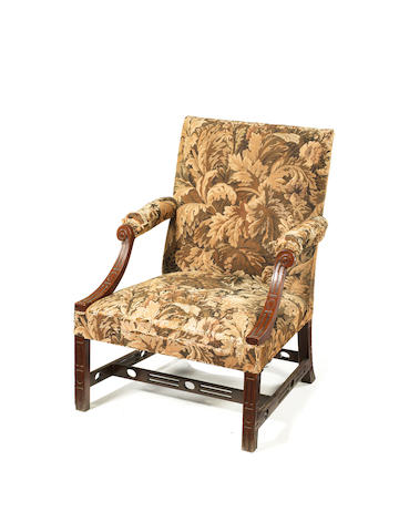 A George III Irish carved mahogany library open armchair