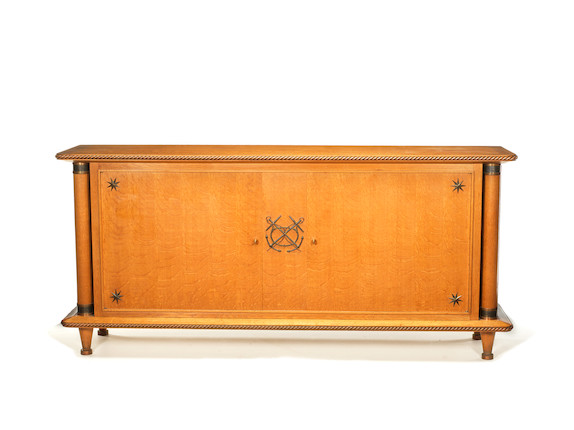 Sideboard French, circa 1935 in the style of Pierre Lardin  oak and gilt metal, the twin doors with keys opening to reveal an interior with two sections each with adjustable shelf  95 by 206 by 51 cm. 37 3/8 by 81 1/8 by 20 1/16 image 1