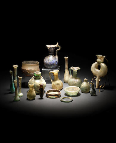 A group of seventeen glass vessels and an amber alabastron, 18