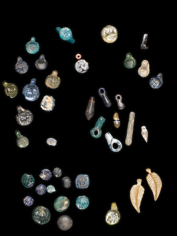 A group of forty-one glass tokens, beads and other items 41