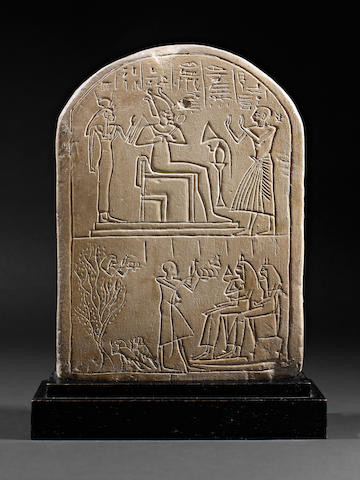 An Egyptian round topped limestone stele