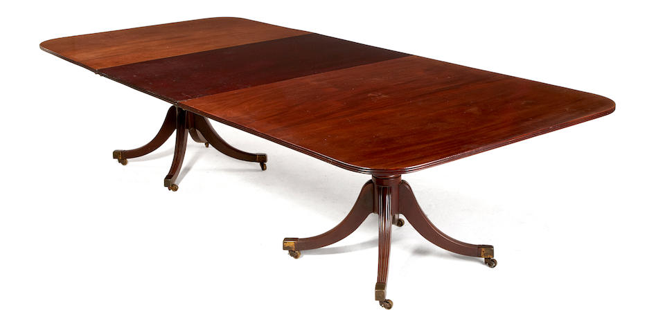 A late George III mahogany twin pedestal dining table