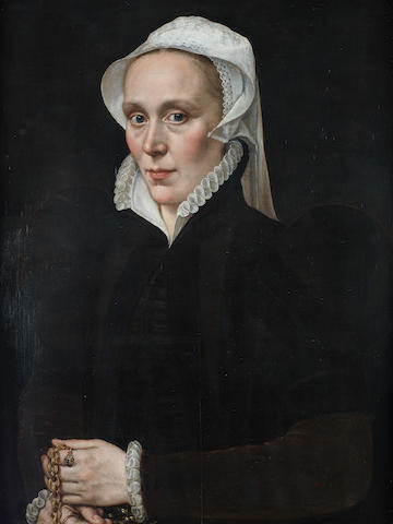 Attributed to Adriaen Thomasz. Key (Antwerp circa 1544-circa 1589) Portrait of a lady, half-length, in a black dress with a white lawn headdress, holding a gold chain