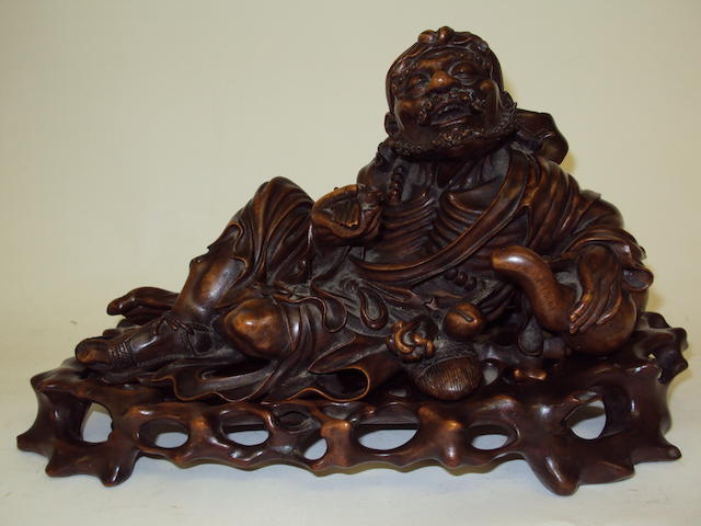 A Japanese rootwood carving of an Oni on stand