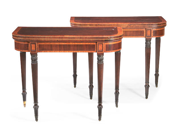 A pair of late George III mahogany and satinwood crossbanded D-shaped card tables
