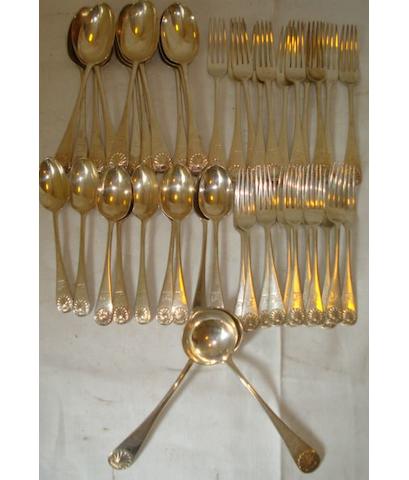 A part canteen of Victorian shell pattern flatware, comprising eleven supper forks, eleven dinner forks, two sauce ladles, and nine dessert spoons, engraved crest by Francis Higgins 1891, 89ozs.