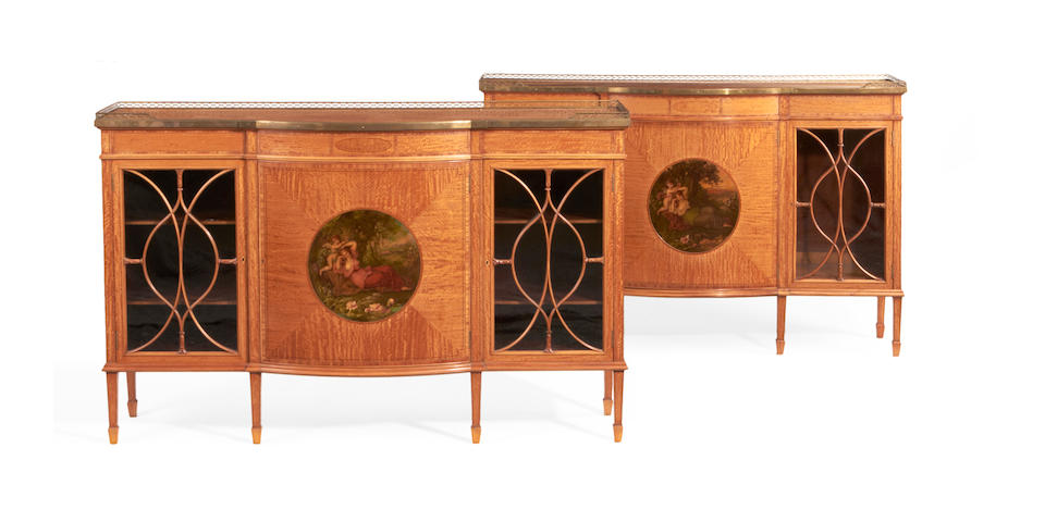 A pair of Edwardian satinwood, tulipwood crossbanded and polychrome decorated side cabinets by Waring & Gillow, in the Sheraton revival style