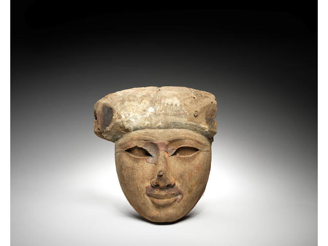 An Egyptian wood sarcophagus mask