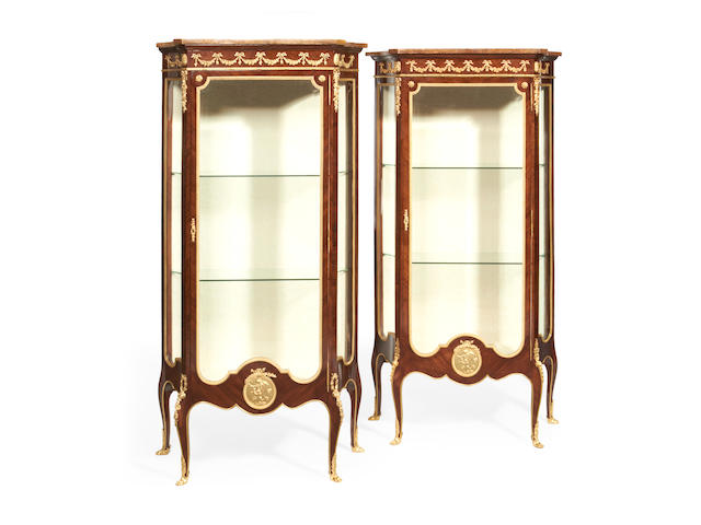 A near pair of French early 20th century gilt metal mounted vitrines in the Transitional Louis XV/XVI style
