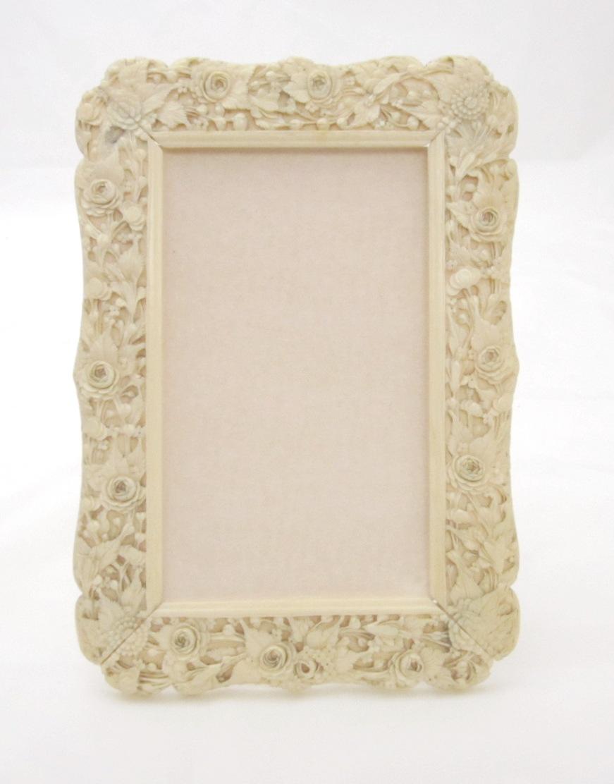 Two Canton export ivory card cases and a carved ivory photograph frame 19th century