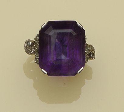 Four gem set rings  Comprising a five stone emerald ring, a large step-cut amethyst cocktail ring, with scrolled diamond set shoulders, a three stone diamond crossover ring, and a pale yellow topaz ring, with diamond set shoulders. (4)