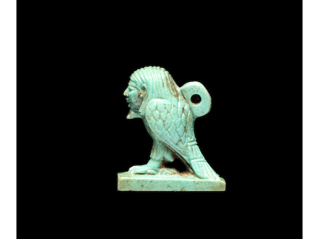 An Egyptian blue-green glazed composition amulet of a Ba bird