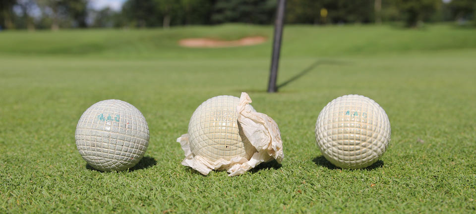 Four mint gutta-percha golf balls with mesh covers circa late 1880s