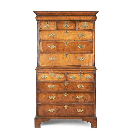 An early 20th century walnut and featherbanded chest-on-chest in the Queen Anne style