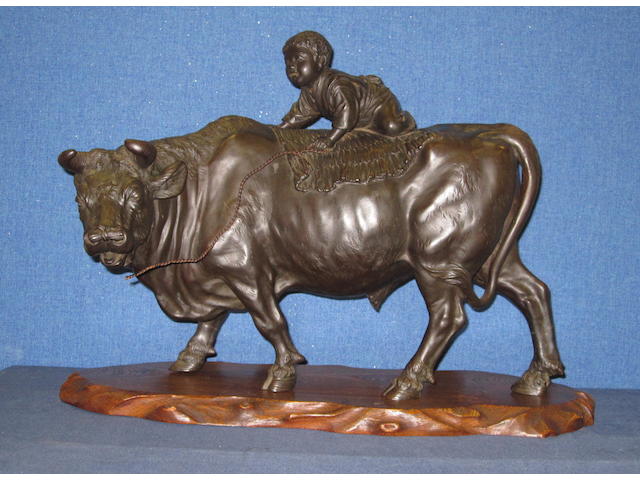A Japanese bronze sculpture of a boy on a buffalo Meiji Period