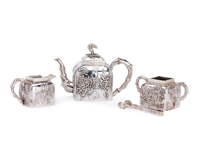 A Chinese silver three piece tea service By Wang Hing, and tongs, (4)