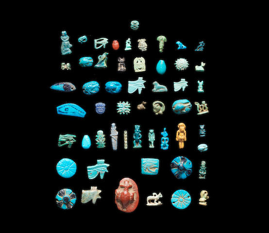A group of Egyptian glass and glazed composition amulets and beads a lot