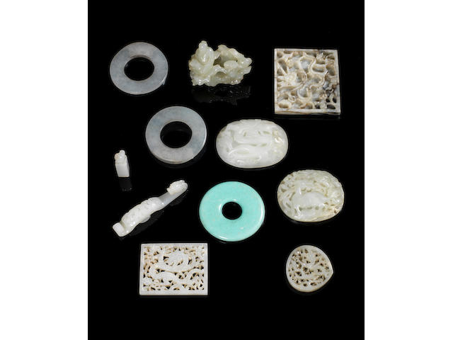 Jade/hardstone/ceramic items comprising ten pierced/carved plaques, four belt hooks/fasteners, two small seals, carved figure with tree root, eight other items, mounts/plaques, part belt hook, archers rings and two green ceramic items