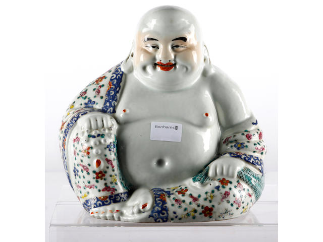 A famille rose porcelain figure of a Buddha and three snuff bottles