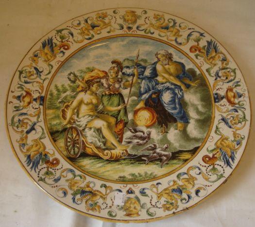 A 19th Century Italian Majolica charger, in the 16th Century manner, centrally painted with classical figures within an Italianate border, 43cm and two others similar, 46cm & 47cm diameter (3)