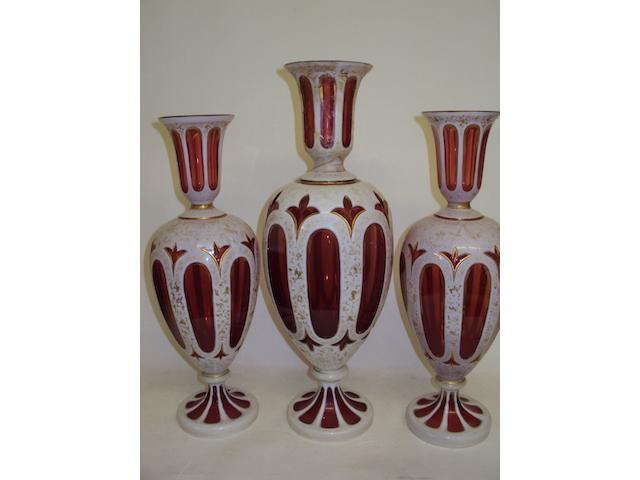 A garniture of Bohemian ruby flashed glass vases