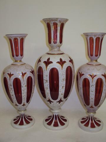 A garniture of Bohemian ruby flashed glass vases
