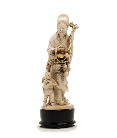 A Chinese ivory figure of a scholar collecting lotus flowers 19th Century