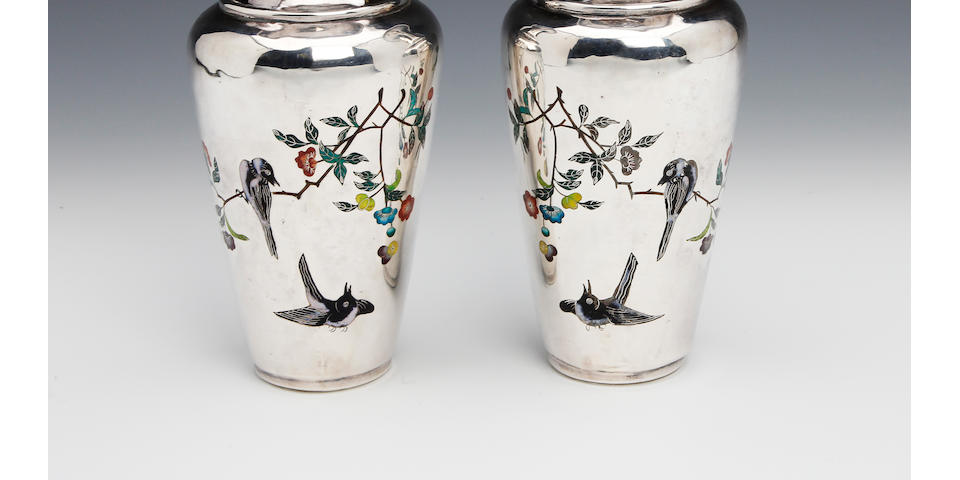 A Chinese silver and enamel pair of baluster vases bearing character marks that translate to "made in Tianjin", North East China, circa 1900