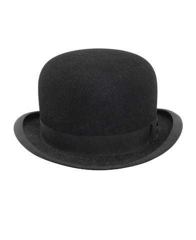 George Harrison / The Beatles: A black bowler hat autographed by George Harrison, circa 1964,