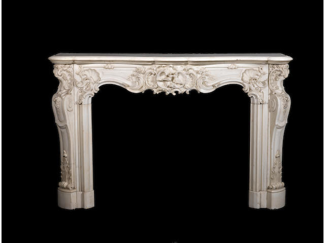 A French mid-18th century Louis XV carved white marble fireplace