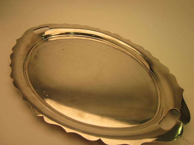 A silver oval two-handled tray, by Walker and Hall, Sheffield date letter worn