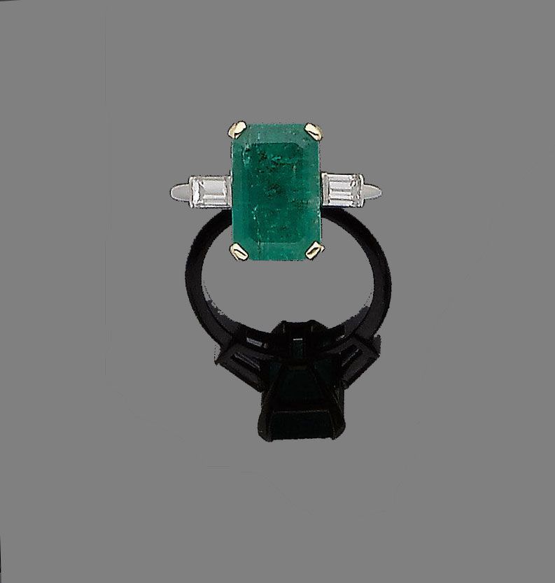 An emerald and diamond ring