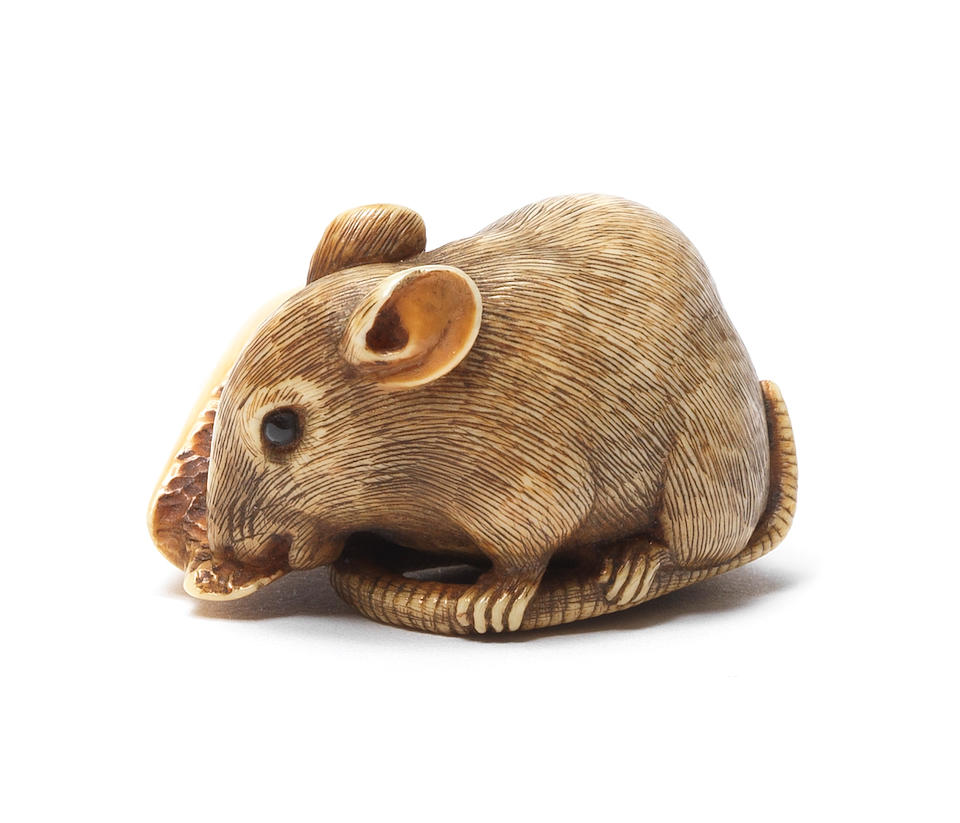 A small ivory netsuke of a rat and candle By Ranseki, Kyoto, 19th century