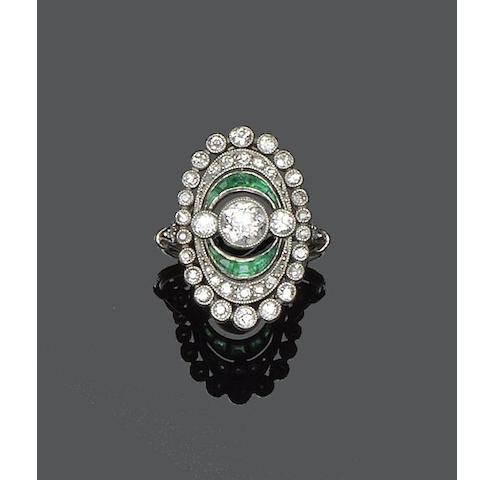 An early 20th century diamond and emerald panel ring