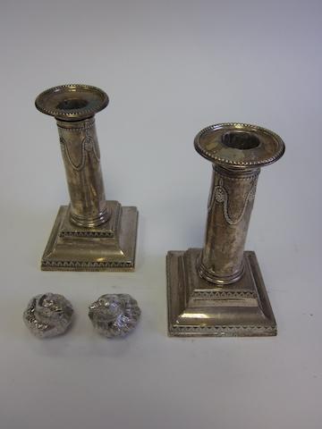 A pair of  silver novelty salt and pepper shakers  by Samuel Mordan & Co, Chester 1905; together with a pair of Adam-style candlesticks, by Thomas Bradbury & Son, London 1900/1901  (4)