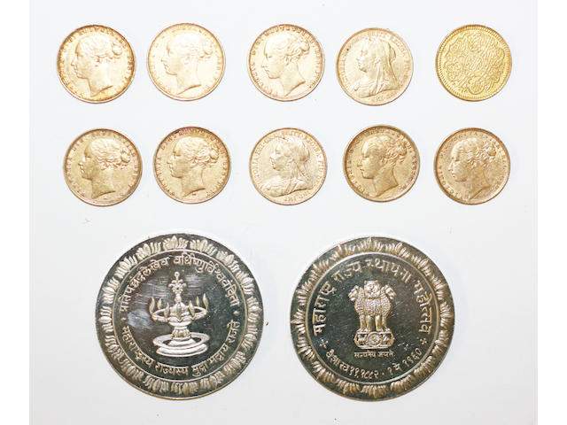 A group of nine sovererigns and a gold Arabic coin and two silver coins,