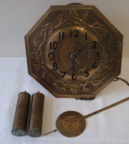 An early 20th Century wall clock, in the Arts & Crafts taste, the octagonal brass dial with Arabic chapter and Celtic knot decoration brass pendulum and two cylinder weight.