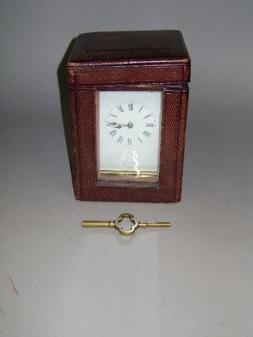 A French brass carriage clock, the enamel dial with Roman numerals, in a corniche case; together with a leather traveling case and key, 17cm high.
