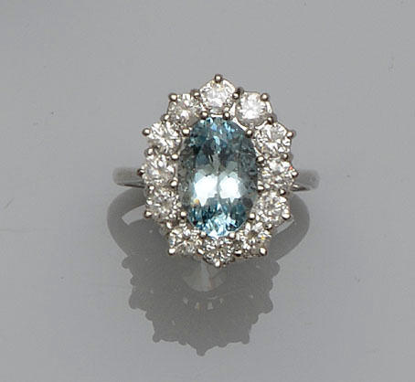 An oval aquamarine and diamond cluster ring