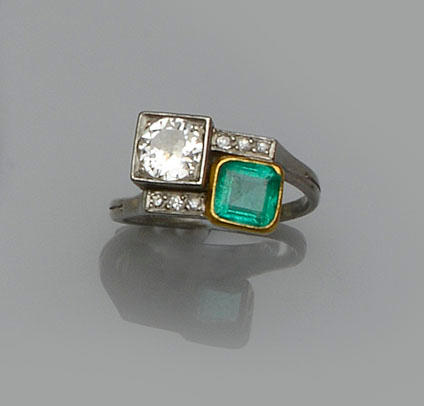 An emerald and diamond crossover ring