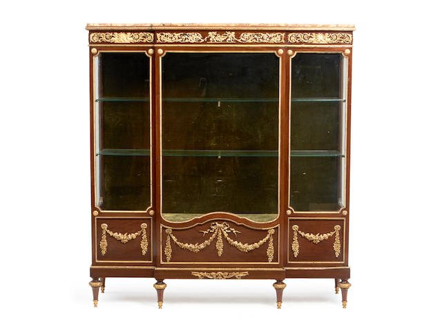 A French late 19th century ormolu mounted mahogany breakfront vitrine in the Louis XVI style