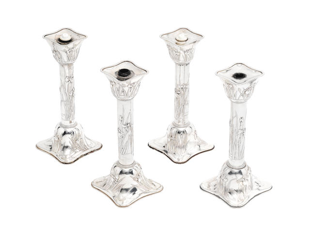 An impressive set of four early-20th century Japanese silver candlesticks stamped 'sterling', retailed by Arthur & Bond, Yokohama
