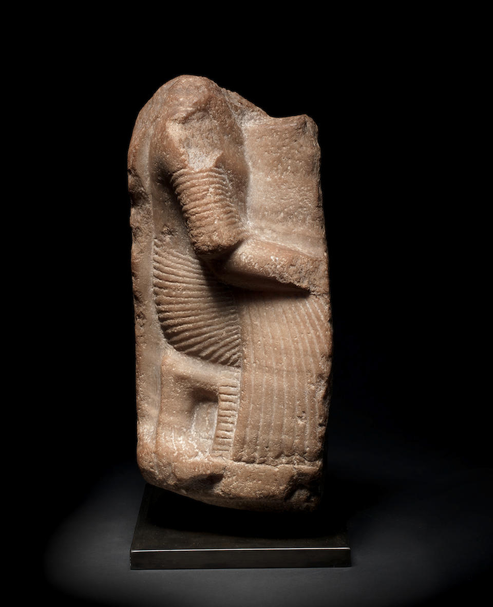 An Egyptian calcite fragmentary kneeling figure